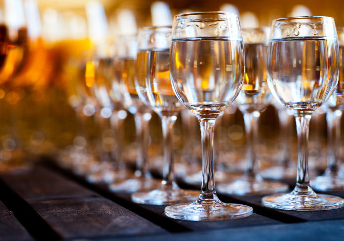 Glasses of vodka on wooden table